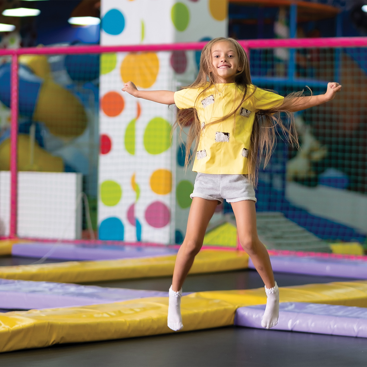 An image of a girl bouncing on a trampoline