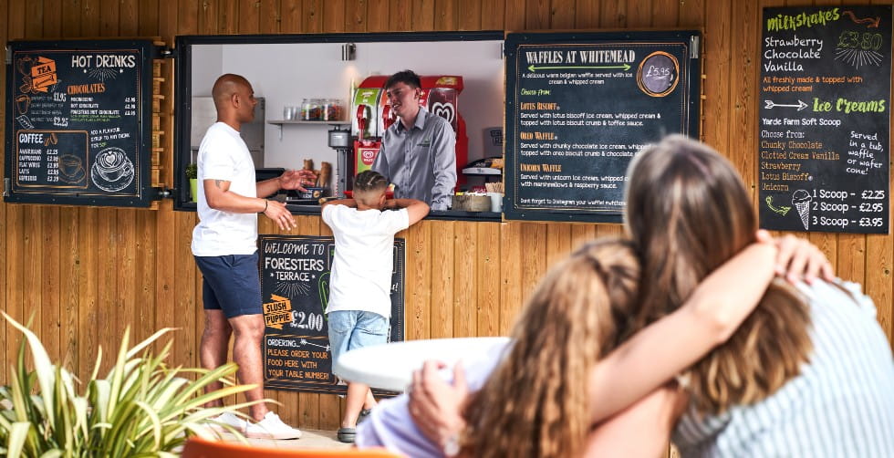 Family ordering food from the Whitemead Forest Park food terrace