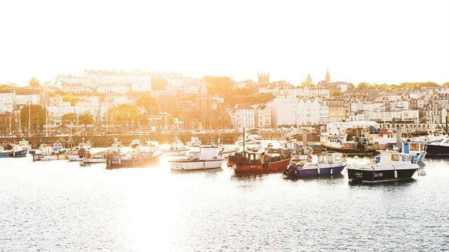 Boats in a Harbour with the sun rising behind