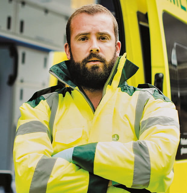 Paramedic standing in front of ambulance