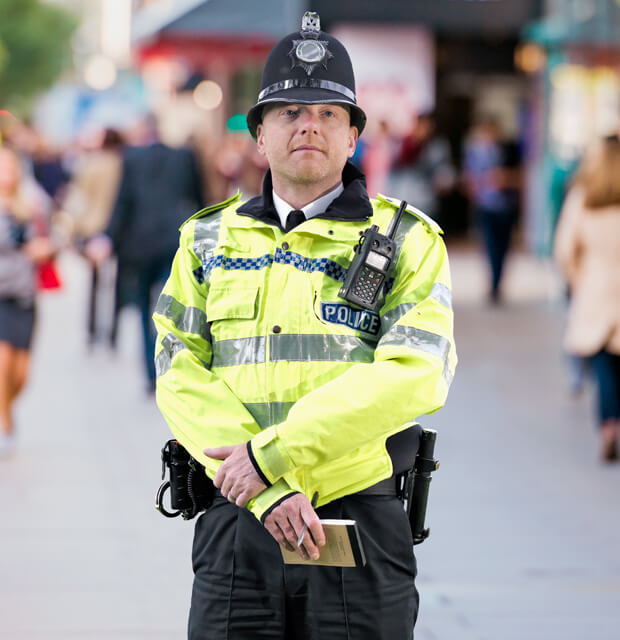 Policeman standing in shopping precinct