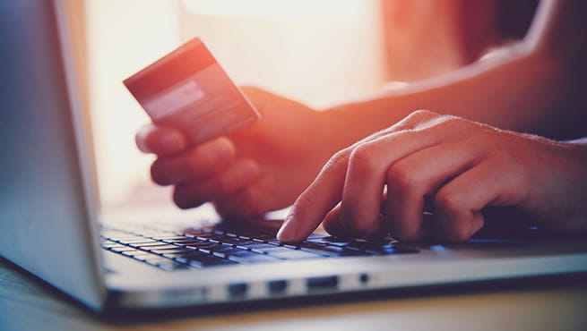 Man using a card to make a online purchase