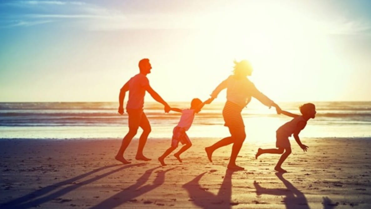 Family on the beach with a sunset