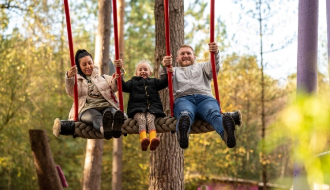 Family on a swing at beWild Cheshire