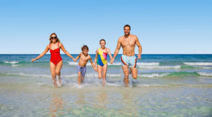 An image of a family playing in the sea at the beach