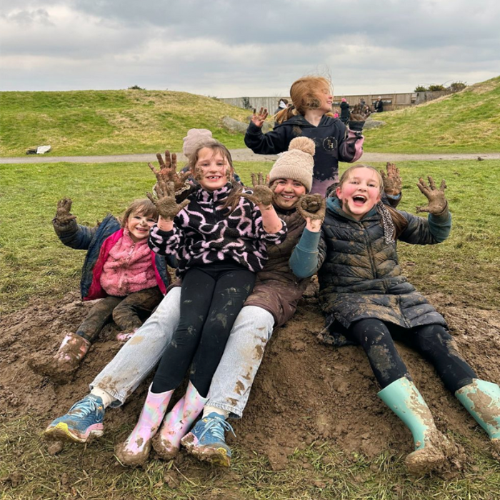 An image of children playing in the mud at a WWT centre