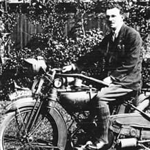 Black and white photo of a man on a motorbike